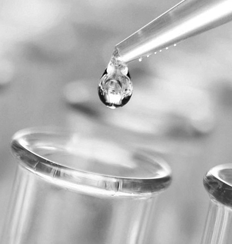 Close up of dripper dripping into test tubes